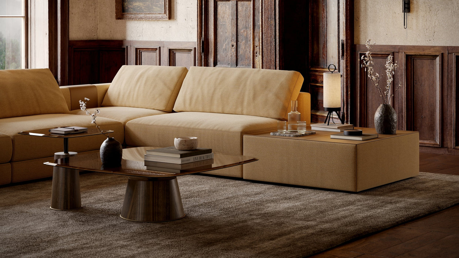Beige sectional sofa in a room with wooden paneling and a rug.